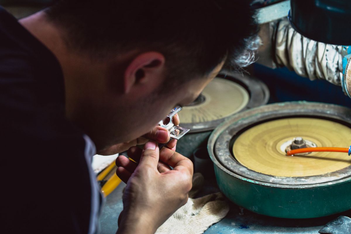 Bench jewelers setting stones under magnification